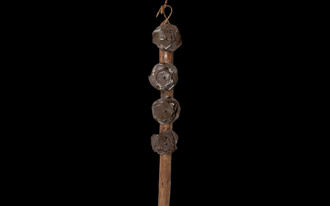 Rattle made from a stick with 4 groups of tin plates attached